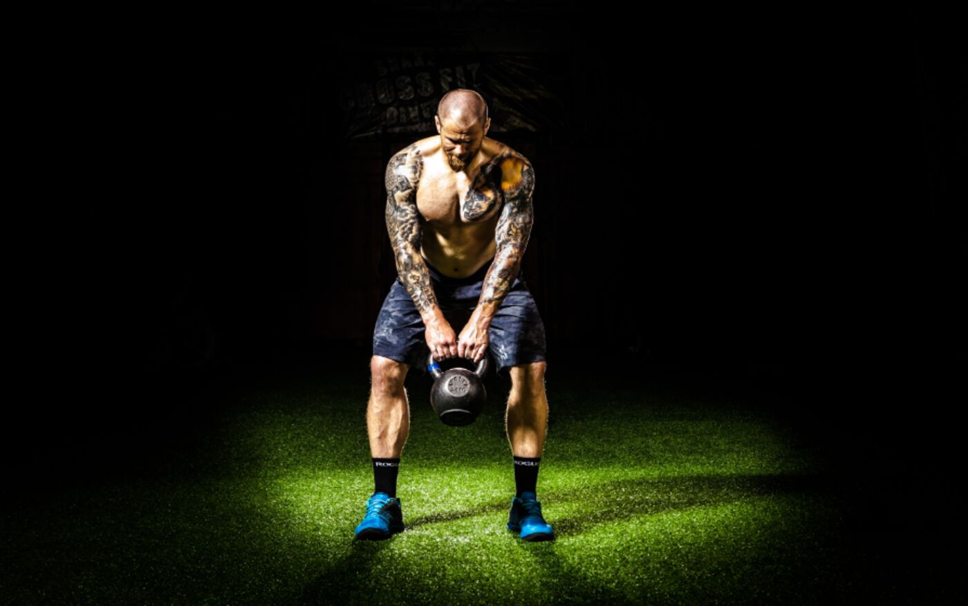 Client performing a kettlebell deadlift during a group training session